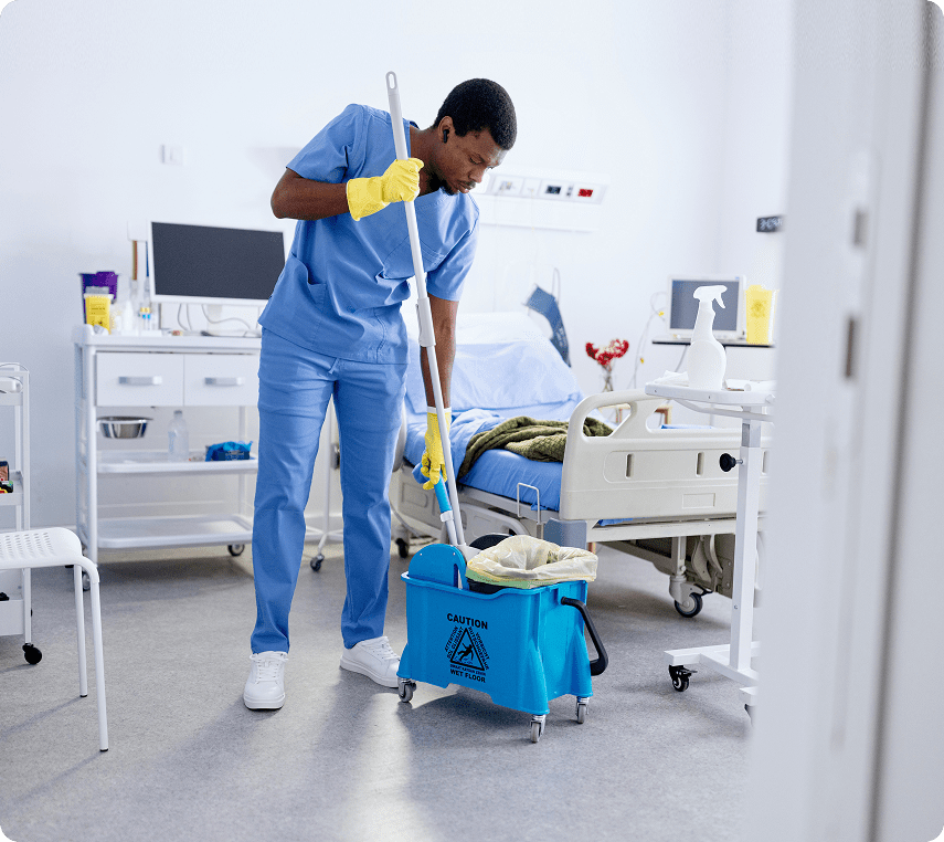 Hospital worker mopping floor