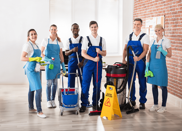 Cleaning crew posing with equipment