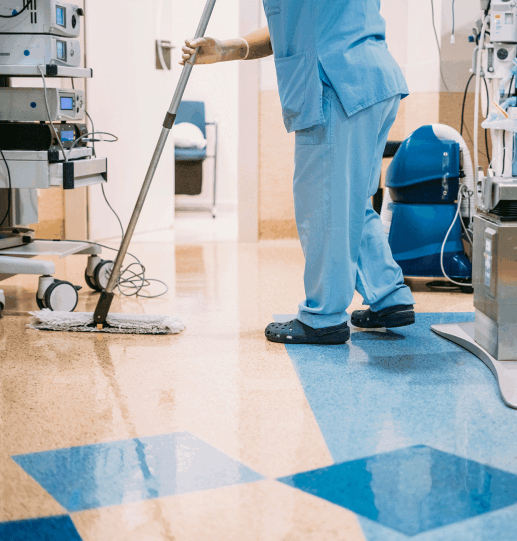 Healthcare worker cleaning hospital room